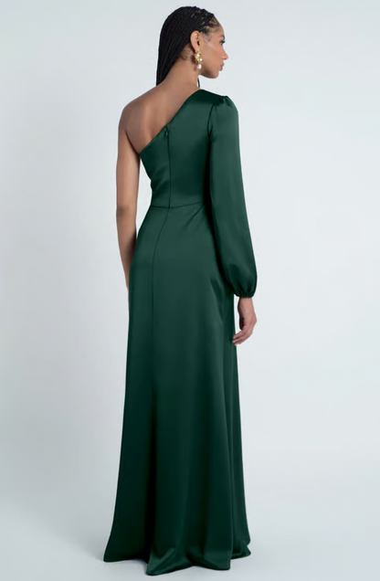 Woman wearing a green one-shoulder gown on a white background