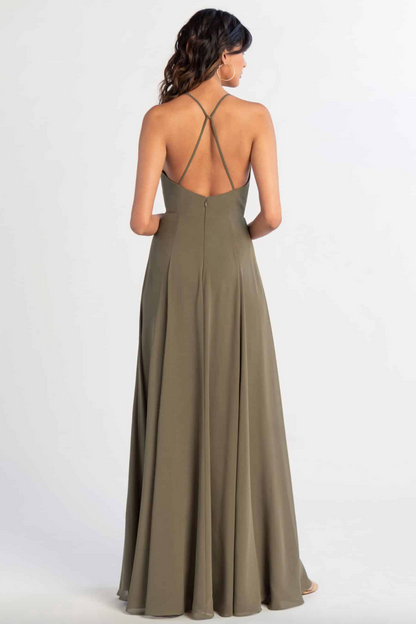 Woman wearing a long olive green dress with thin straps on a white background