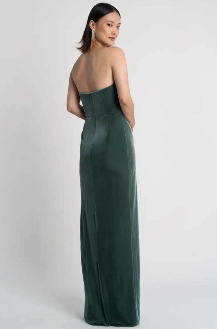Woman wearing a green strapless gown on a white background
