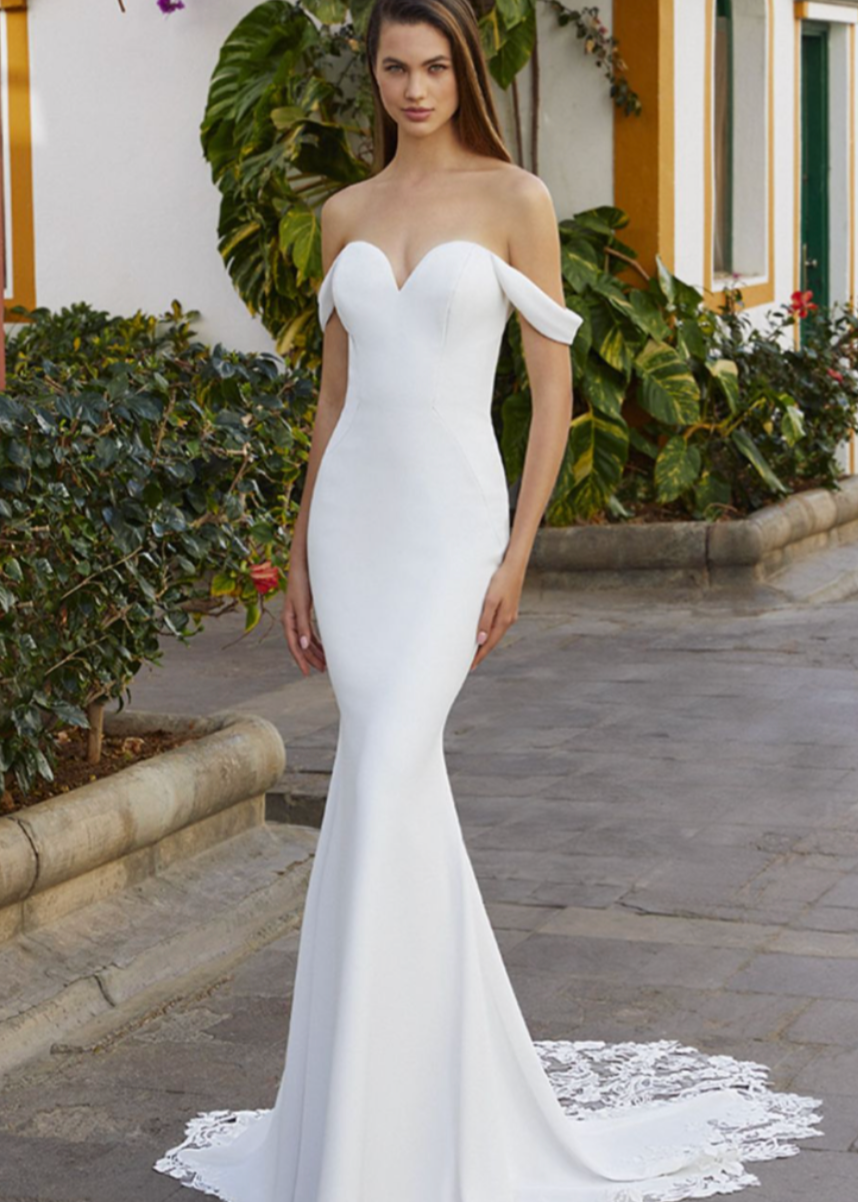 A classic and timeless silhouette is finished off with a gorgeous lace train, sheer back and off the shoulder sleeves.