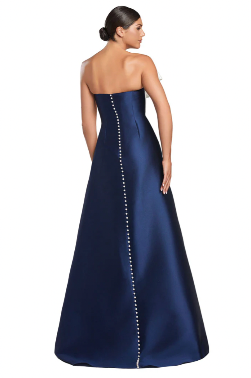 Navy strapless gown with pearl detailing on a white background