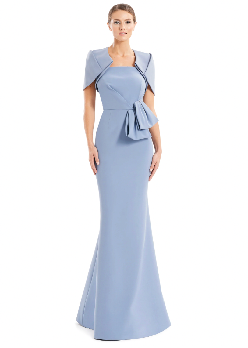 Woman wearing a light blue evening gown with a fitted skirt and cap sleeves on a white background