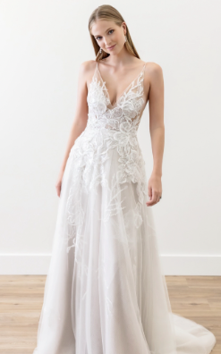 Fabia is a romantic a-line wedding dress, with lace flowing from the tops down to the skirt, and a small train.