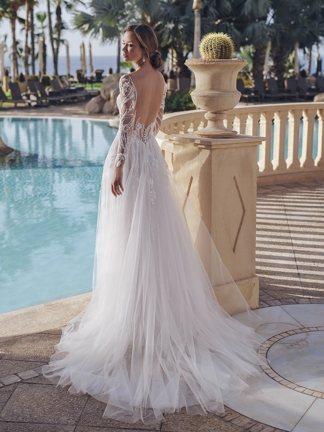 This geometric beaded lace A-line gown is a vision of bridal beauty, and its illusion long sleeves with beaded leafy lace give a mystical, enchanting vibe. The figure-flattering illusion lace bodice hugs the curves, while the flared glitter tulle and soft tulle skirt creates a sense of drama and romance, ensuring you make a lasting impression on your wedding day.