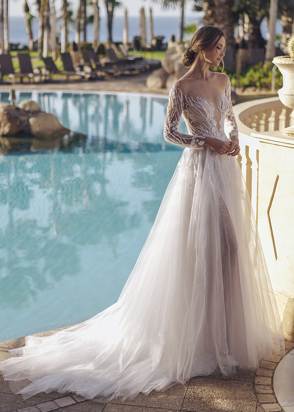 This geometric beaded lace A-line gown is a vision of bridal beauty, and its illusion long sleeves with beaded leafy lace give a mystical, enchanting vibe. The figure-flattering illusion lace bodice hugs the curves, while the flared glitter tulle and soft tulle skirt creates a sense of drama and romance, ensuring you make a lasting impression on your wedding day.