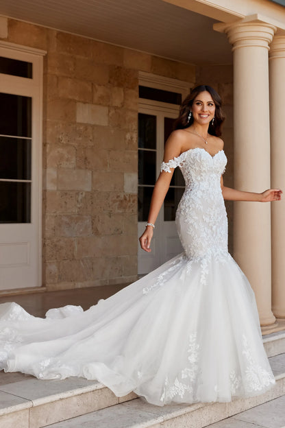 mermaid nweetheart wedding dress with lace down the bodice, off the shoulder sleeves and a tulle skirt & train. Available at Never Knew I Needed