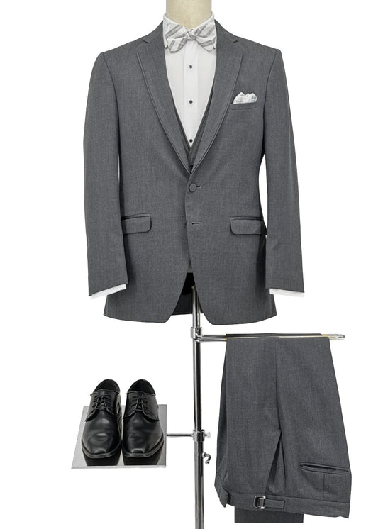 Gray suit with white shirt, black bow tie, and shoes on a mannequin.