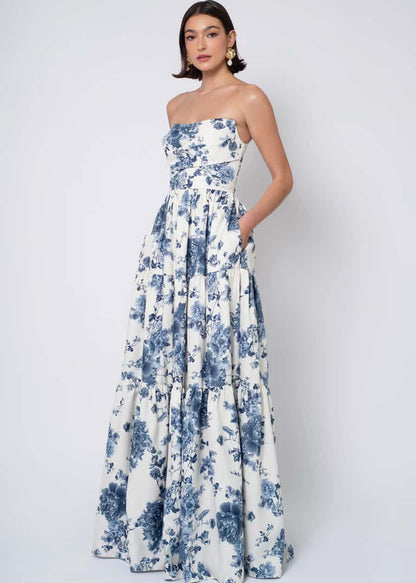 Woman wearing a strapless floral dress against a white background
