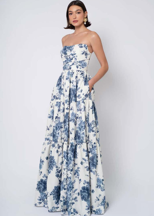 Woman wearing a strapless floral dress against a white background