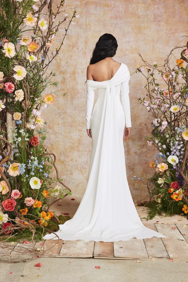 Young woman wearing an asymmetric neckling fitted wedding dress