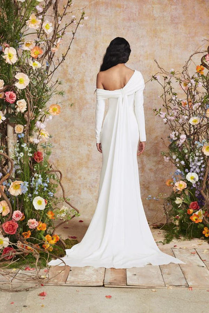 Young woman wearing an asymmetric neckling fitted wedding dress