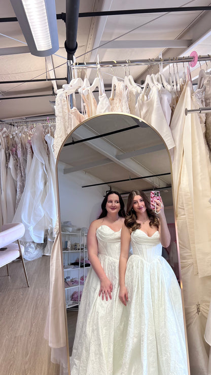 Olivia and Dali wearing the Violetta Basque A-Line wedding dress