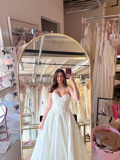 Dali wearing the Violetta wedding dress at NKIN. Strapless sweetheart neckline with  Brocade Aline  skirt featuirng a corset style basque waist 