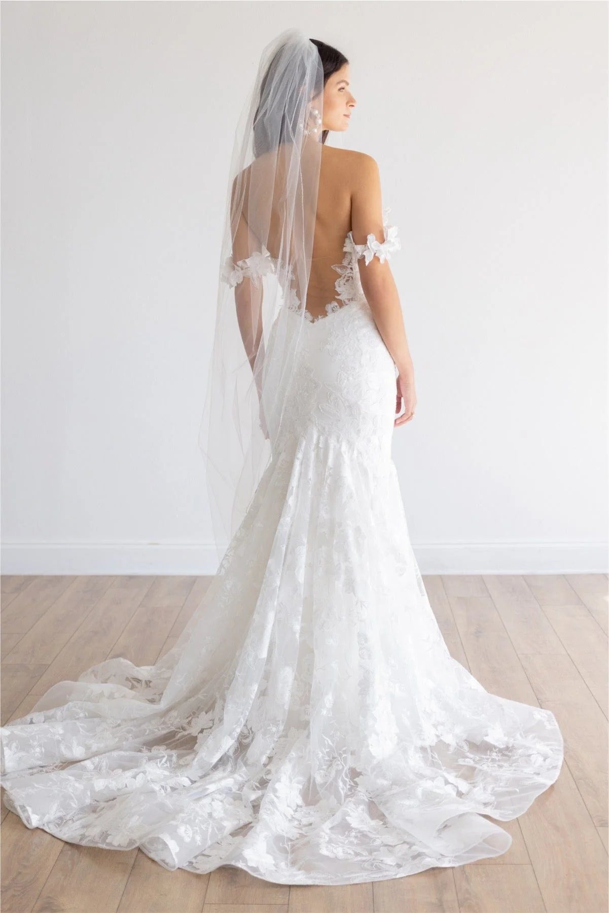 This fit and flare silhouette has gorgeous Camellia Floral Lace from head to toe. The Stretch Poly Charmeuse lining allows for comfort while her modern plunge and open illusion back show off your silhouette. Off the shoulder sleeves will give you the sleeve look without adding too much coverage.


