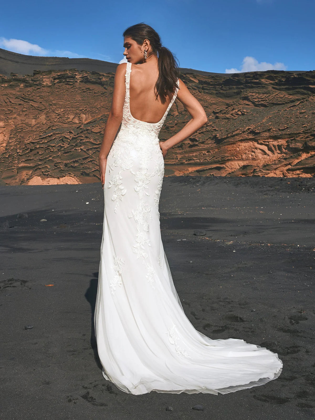 Young woman wearing a square neck wedding dress with floral lace