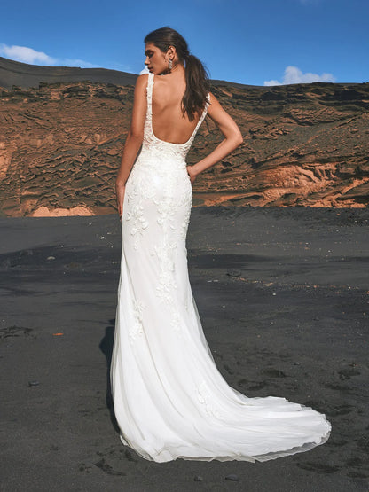 Young woman wearing a square neck wedding dress with floral lace
