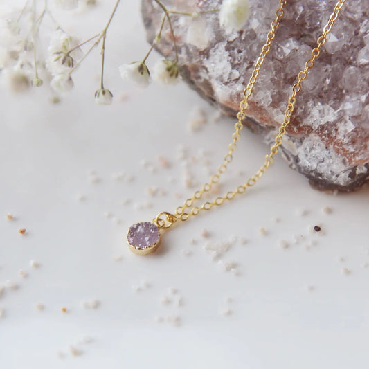 Dainty druzy necklace on a white and crystal background