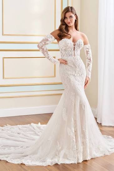model showing off strapless mermaid wedding dress with floral tulle and detachable sleeves, available at NKIN