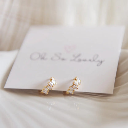 Sunny Huggie Hoops - gold mini hoops on a jewelry back drop