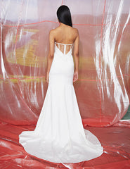 Model wearing Dove by Theia Couture - a strapless fit and flare wedding dress, - full body back view