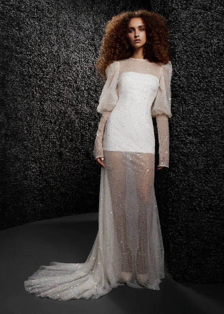 Model wearing Eugenie by Vera Wang - long sleeve fully beaded sheath wedding dress, full body front view