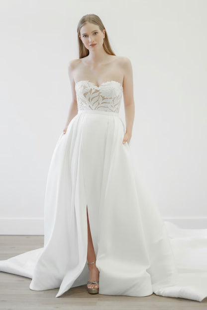 Fun and flirty, the June gown offers you two looks in one. A custom beaded mini dress is paired with this stunning Mikado and Organza overskirt.