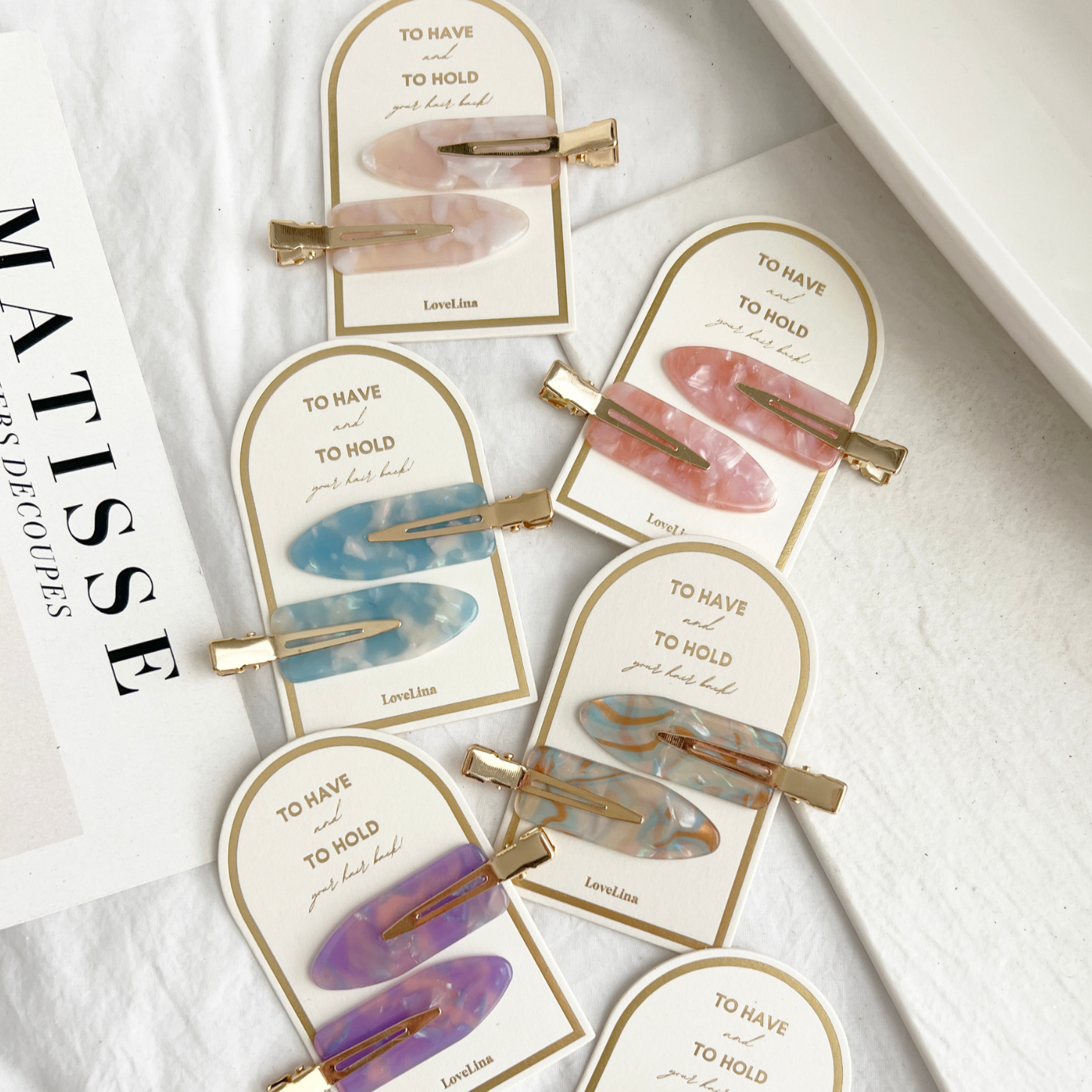 Crease free hair clips ona. gold and white backing that says "To Have and To Hold Your Hair Back"