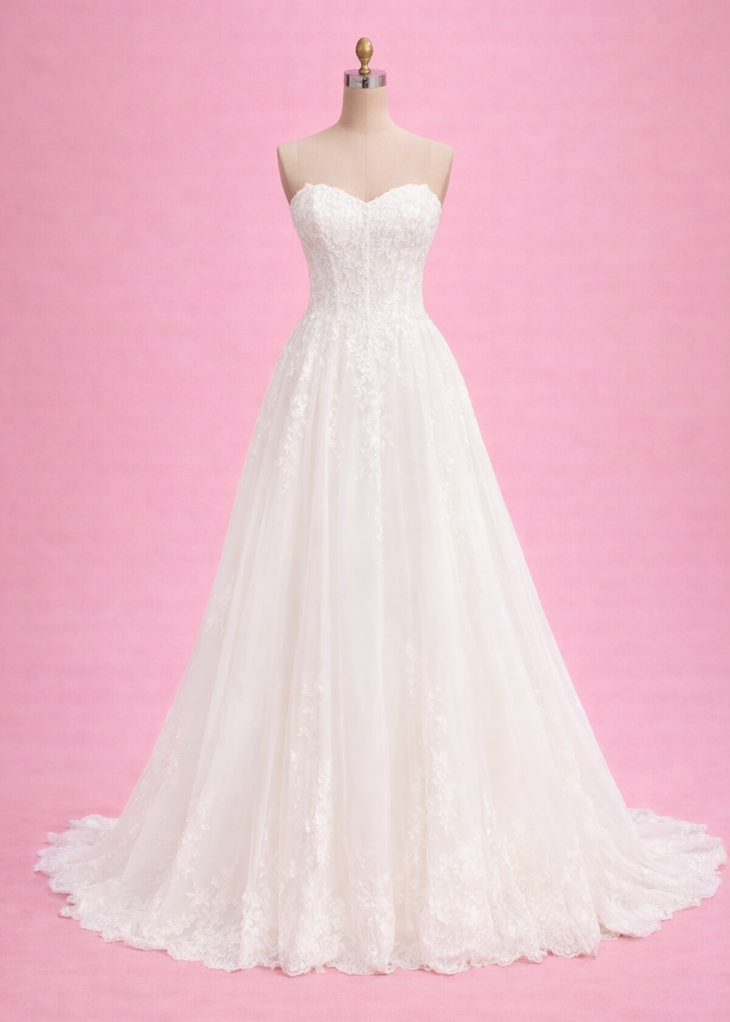 White wedding dress on a mannequin against a pink background