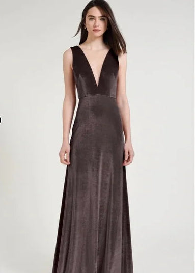 Woman wearing a dark brown evening gown on a white background