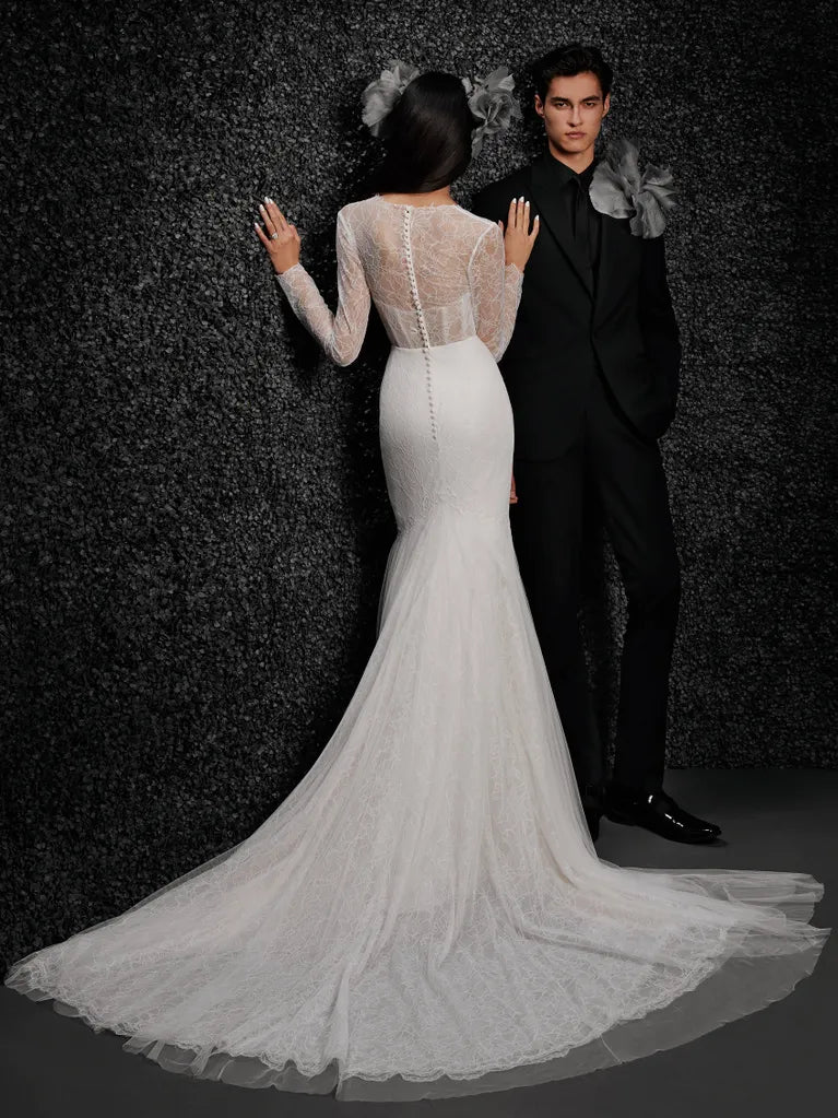 Model wearing Monique by Vera Wang - a mermaid lace wedding dress with long sleeves and a deep V,, full body back view