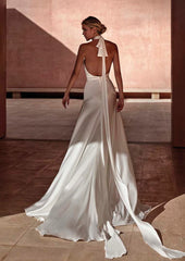 Model wearing Antalya by Pronovias -a a sheath halter neck wedding dress with an open back, full body back view