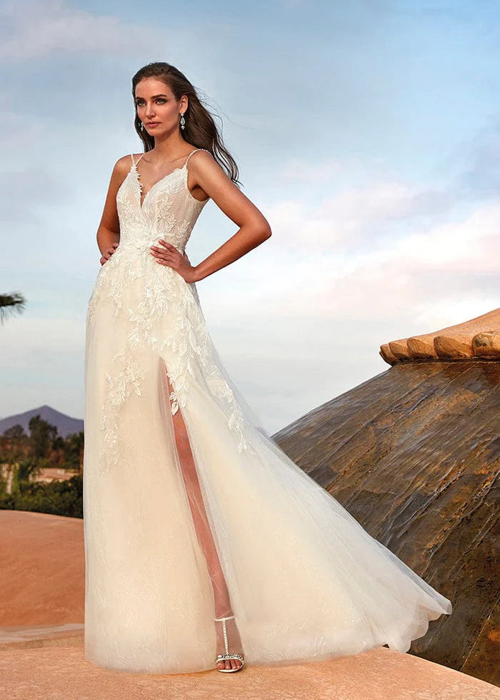 Mdoel wearing Kansai by Pronovias - v neck a line with floral lace throughout and a slit, full body front view