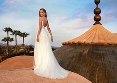 Mdoel wearing Kansai by Pronovias - v neck a line with floral lace throughout and a slit, full body back view