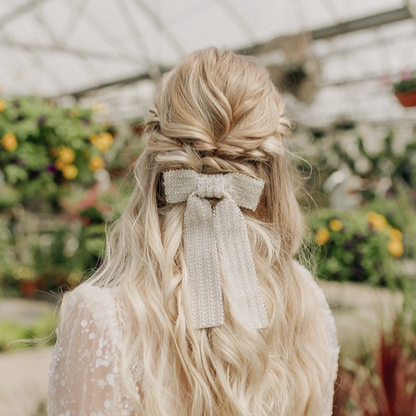 Young woman with blonde hair wearing a beaded ivory bow