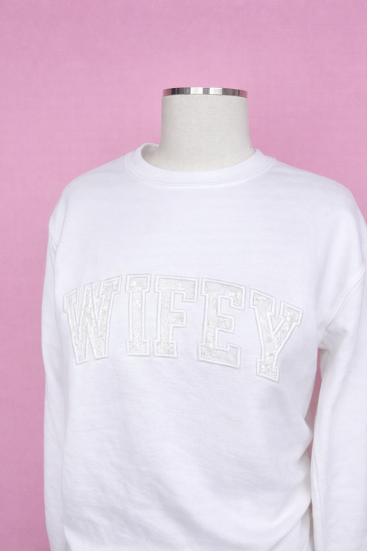 White sweatshirt with 'WIFEY' text on a pink background, keepsake wedding dress. After the vows