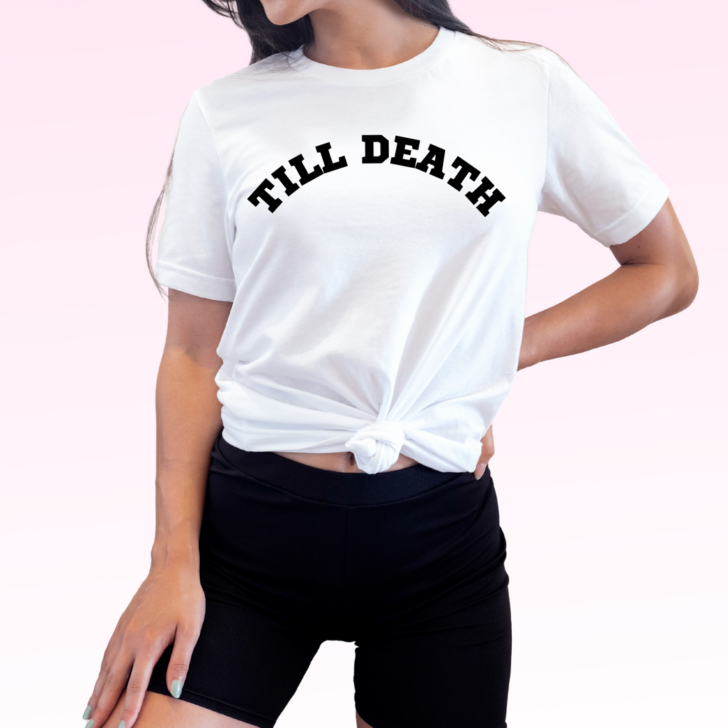 A young woman wearing a white t shirt with "till death" printed in black. A super unique engagement gift.