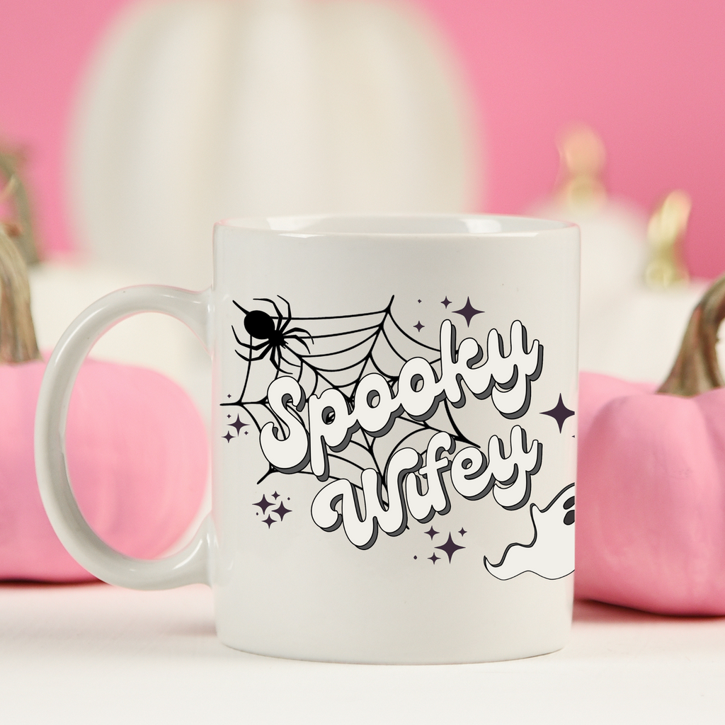 A white ceramic mug with "spooky wifey" printed on it. A super cute halloween inspired gift for the bride.