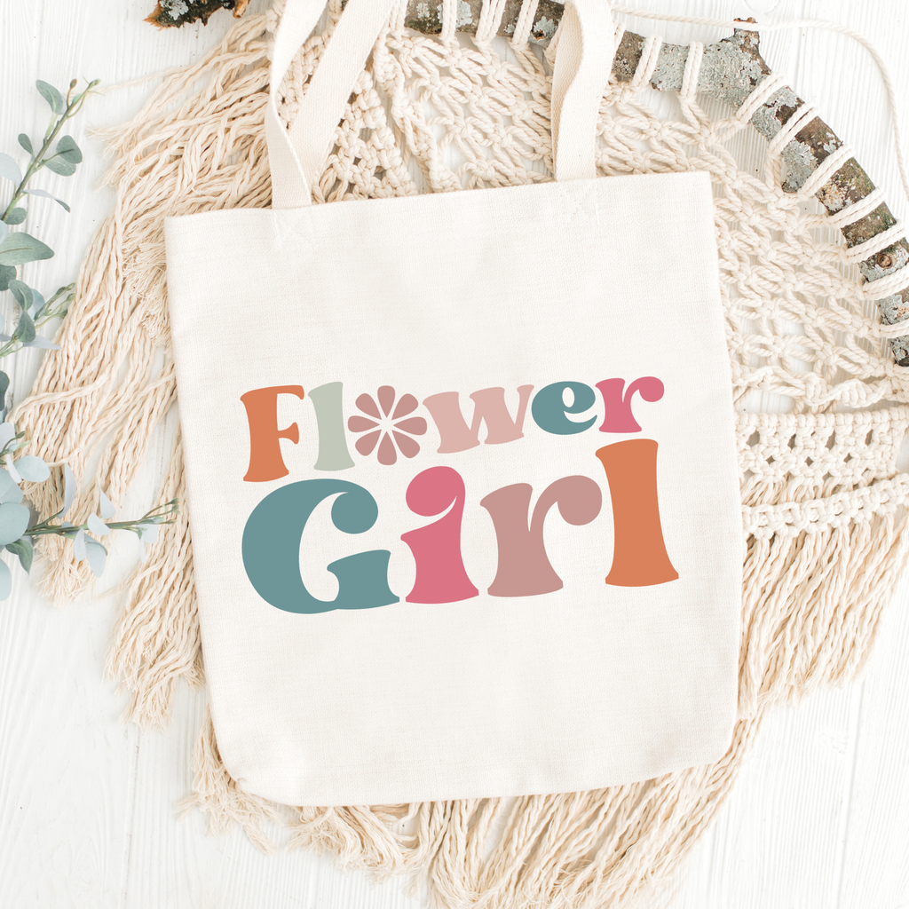 Brown tote bag with "flower girl" written in retro letters.