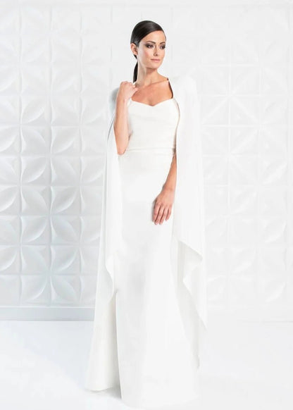 A young woman wearing a simple white wedding dress