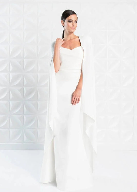 A young woman wearing a simple white wedding dress