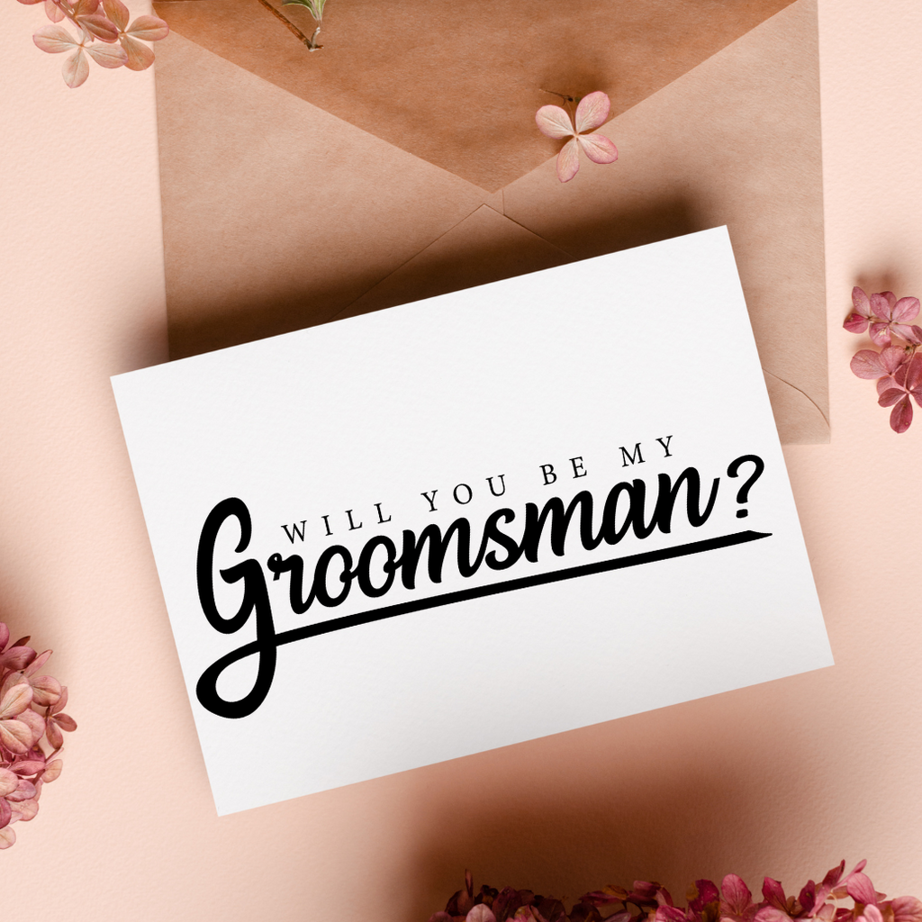 "Will you be my groomsman?" written on a white card on a brown background