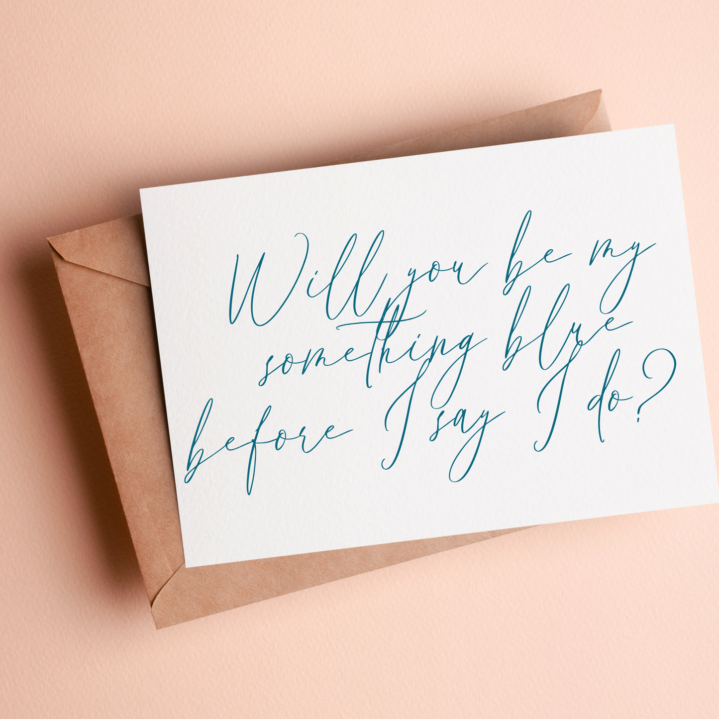 White card that says "will you be my something blue before I say I do?" written in blue