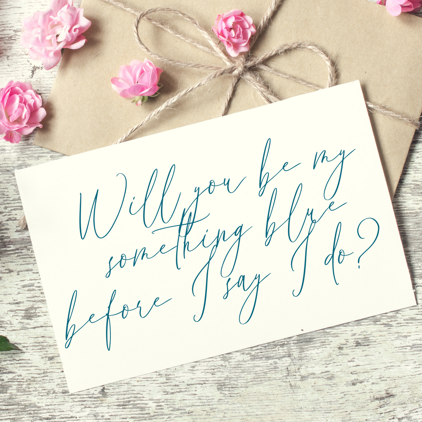 White card that says "will you be my something blue before I say I do?" written in blue