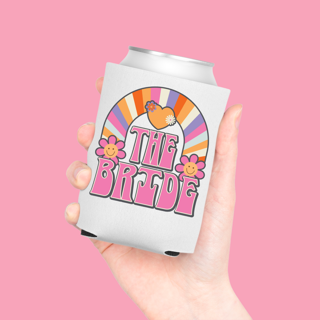 A can in a white koozie with "The Bride" printed in pink retro font.