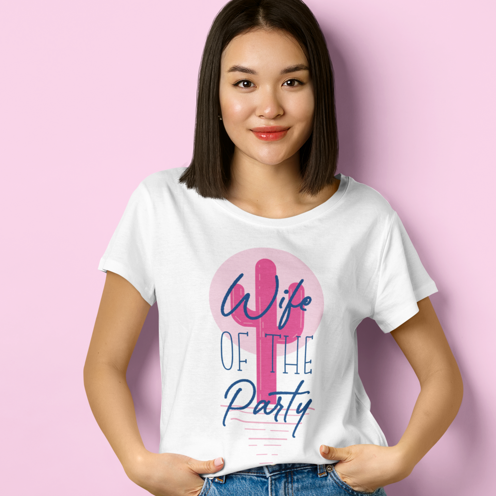 A white shirt with "wife of the party" written on top with a pink cactus background. Worn by a young woman on a pink background. Great for a scottsdale/arizona bachelorette!