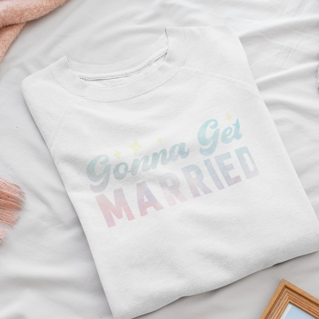 A white crewneck with the words "gonna get married" written in a pale pink/blue. A great gift set for the bride.
