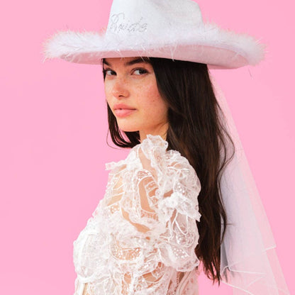 Woman wearing our white "bride" cowboy hat with a mini veil