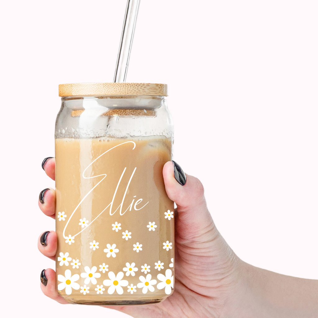 Simple glass coffee tumbler with "Ellie" written on it with daisy florals.