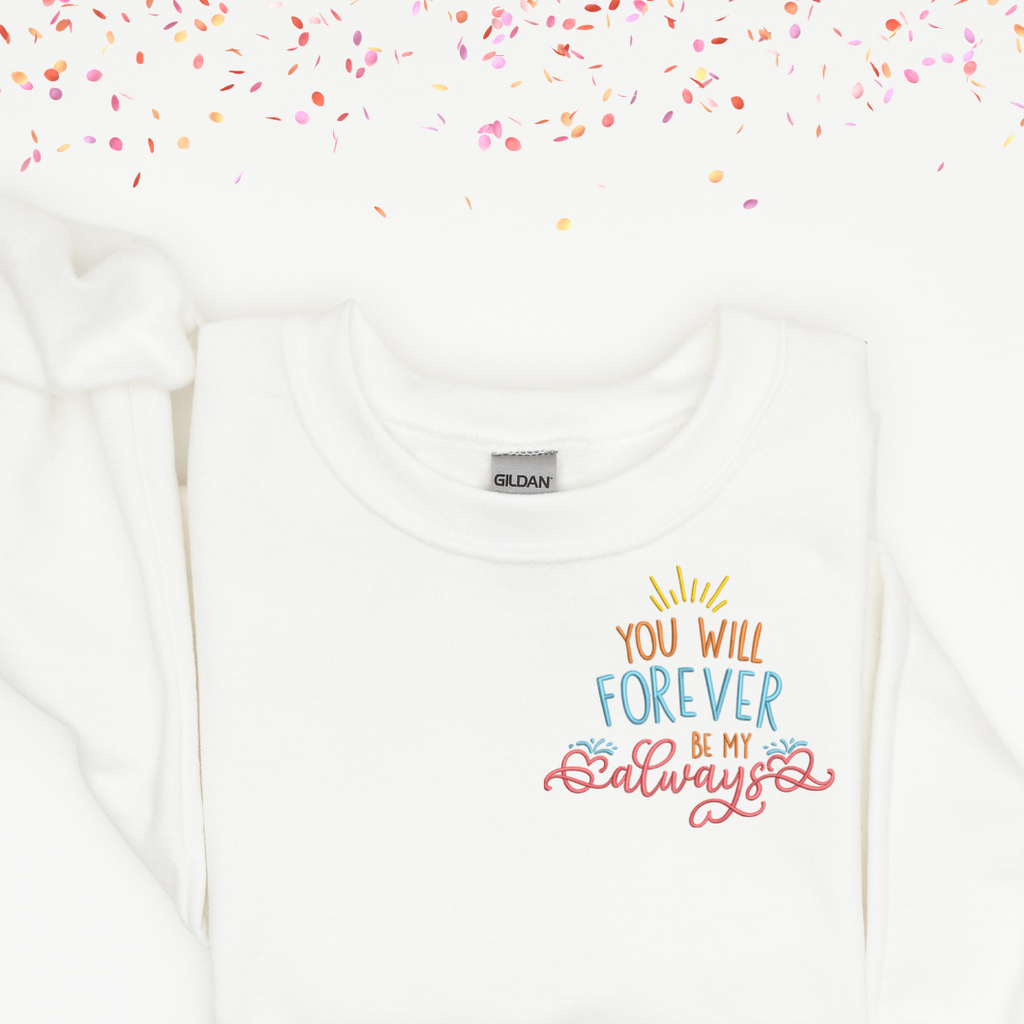 A white crewneck with "you will forever be my always" embroidered in the left hand corner.