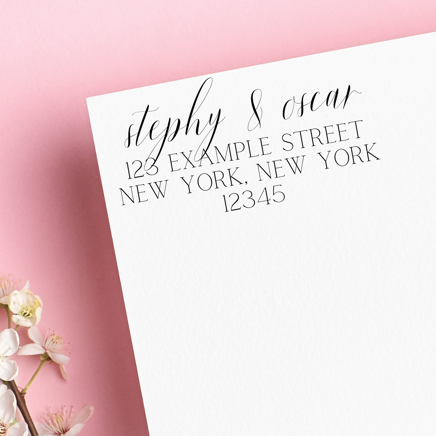 A stamp on white envelope. It reads "stephy & oscar" written in calligraphy, with block letters below. Left on a pink background. A great housewarming gift!